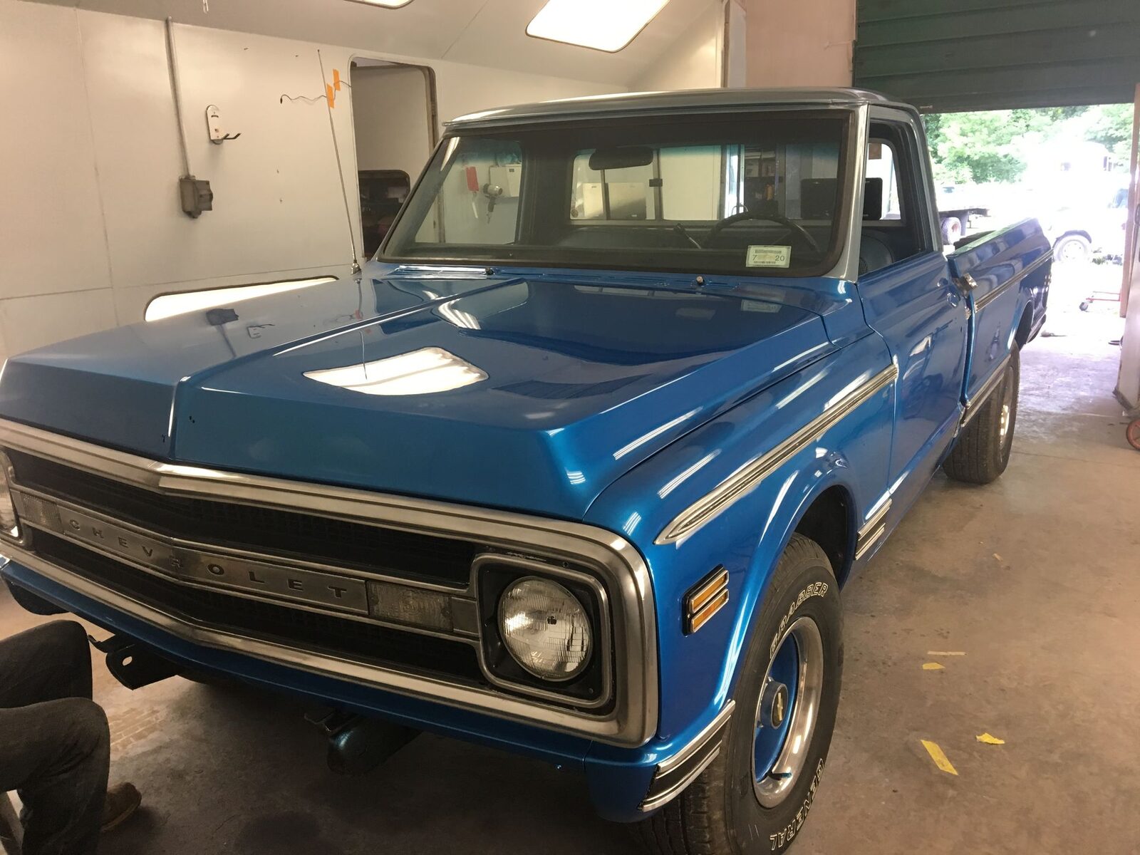 A restored classic pickup truck in the Just Joe's repair bay