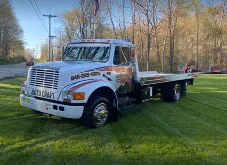 The Just Joe's flatbed tow truck out on the road